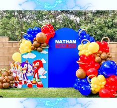 balloons and decorations are on display in front of a backdrop for a sonic the hedgehog birthday party