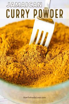 a fork sticking into curry powder in a bowl with the words, jamaican curry powder