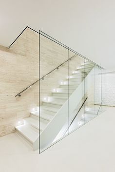 a staircase with glass railing and white steps