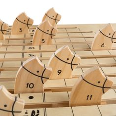 several wooden pieces with numbers on them are arranged in the shape of people's heads