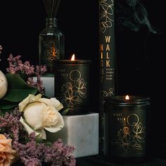 candles and flowers are on display in front of smokestacks, which also include roses