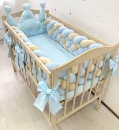 a baby crib with blue and beige decorations