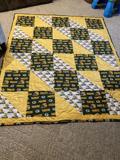 a green bay packers quilt on the floor