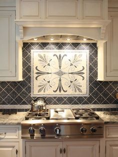 a stove top oven sitting inside of a kitchen next to a wall mounted tile mural