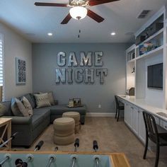 a living room filled with furniture and a ceiling fan