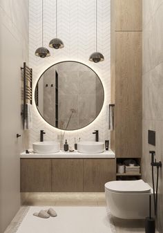 a bathroom with two sinks and a round mirror