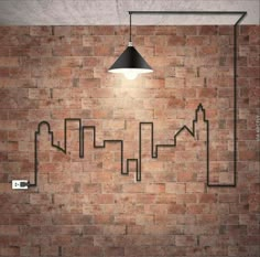 a brick wall with a lamp on it and an image of buildings drawn on the side