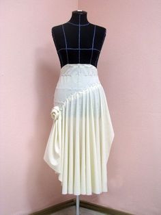 a mannequin wearing a white dress with black and blue stripes on the skirt