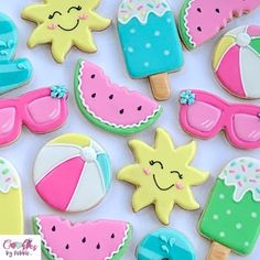 decorated cookies are arranged in the shape of sun, watermelon and umbrellas