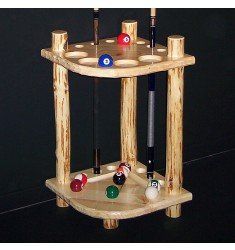 a wooden rack with pool balls and cues in it on a black table top