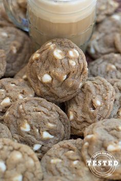 chocolate cookies with white sprinkles and a jar of peanut butter