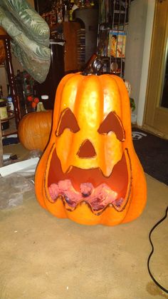 a pumpkin carved to look like a jack - o'- lantern with its mouth open