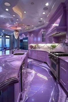 a kitchen with purple marble counter tops and cabinets, along with a chandelier hanging from the ceiling