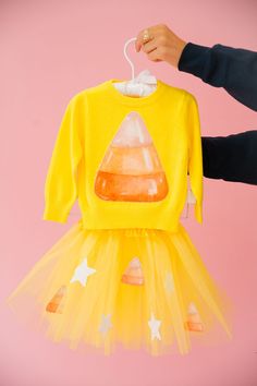 Get ready to sweeten up your little one's wardrobe with our Mini Kids Candy Corn Yellow Sweater! This cozy knit sweater features a playful candy corn design, adding a pop of fun to any outfit. Perfect for chilly days or Halloween festivities. All orders are currently shipping within 14 business days. To receive item quicker, expedited shipping is available at checkout. **ALL HALLOWEEN ORDERS MUST BE PLACED WITH EXPEDITED SHIPPING TO GUARANTEE DELIVERY BY OCT. 31 IF PLACED AFTER OCT. 15**