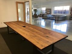 a large wooden table sitting in the middle of a room