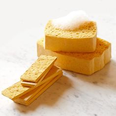 two slices of bread with cheese on top and some sugar in the middle, sitting on a marble surface