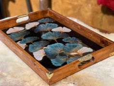 a wooden box filled with blue flowers on top of a white furnishing floor