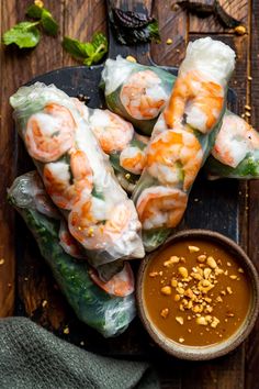 shrimp spring rolls with dipping sauce on the side