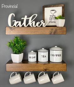 two wooden shelves with coffee mugs on them and a potted plant in the corner