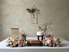 the table is set up with flowers and cards for guests to sign their marriage vows