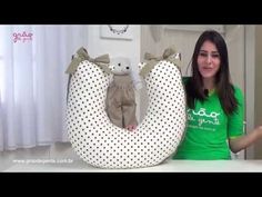 a woman standing next to a stuffed animal in the shape of a letter o with polka dots