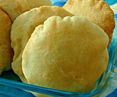 some bread rolls in a blue basket on a table