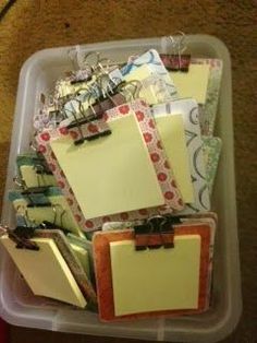 a plastic container filled with lots of notes and clipboards