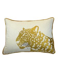 a white and gold pillow with a leopard on it's face in front of a white background