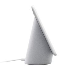 an electronic device is plugged into the side of a white cone shaped speaker system