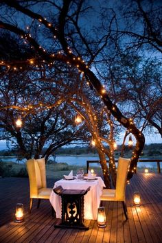 an outdoor dining area with candles and lights