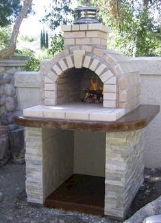 an outdoor brick pizza oven built into the side of a wall