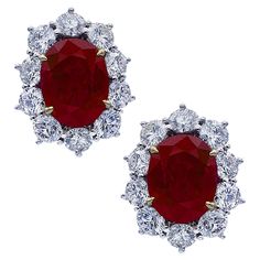 Breathtaking Ruby and Diamond Stud Earrings crafted in Platinum and 18K Yellow Gold featuring two oval cut rubies weighing 10.66 carats total accented by 20 round brilliant cut diamonds weighing approximately 5.00 carats total, G-H Color, VS- SI clarity. These two charming rubies are fashioned into enchanting flowers, capturing the unparallel beauty of nature, surrounded by petals detailed with diamonds. The earrings measuring 16.3mm by 20.3mm. They weigh 13.8 grams and have posts and omega backs. Our pieces are all accompanied by an appraisal performed by one of our in-house GIA Graduates. They are also accompanied by GIA grading report(s), AGL grading report(s), original certificate(s) and other documents, if specified in the listing. We guarantee all products we sell and our number one Enchanted Flowers, Ruby And Diamond Earrings, Ruby Jewel, Diamond Stud Earrings, Earring Crafts, Ruby Diamond, Diamond Stud, Round Brilliant Cut Diamond, Diamond Earrings Studs