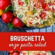 broccoli and pasta salad in a bowl with tomatoes on the side, next to another dish