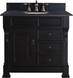 a black bathroom vanity with two sinks