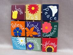 wooden blocks decorated with colorful flowers and words that say peace, love, joy, nativity, kindness, godness, self - control