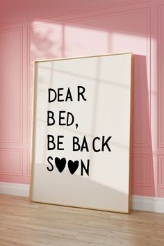 a poster with the words dear bed, be back soon on it in front of a pink wall