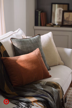 a white couch with many pillows on it