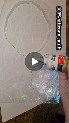 someone is painting the inside of a white piece of paper with acrylic paint