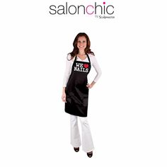 a woman wearing an apron with the words salon chic written on it and smiling