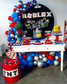 a table with balloons and decorations on it