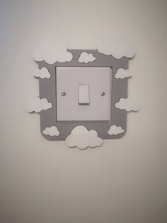 a white light switch sitting on top of a wall