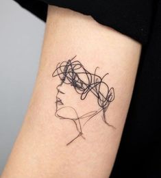 a woman's arm with a black and white line drawing on the side of it