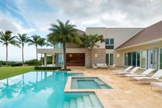 a large swimming pool with lounge chairs next to it