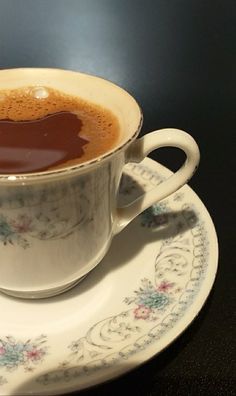 a cup of hot chocolate sitting on top of a saucer