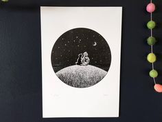 a black and white drawing of a person sitting on top of a hill at night