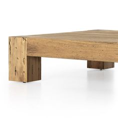 a wooden table that is made out of wood and has one leg on the other side