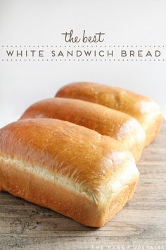 three loaves of bread sitting on top of a wooden cutting board with the words, the best white sandwich bread