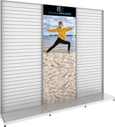 an outdoor display featuring a woman doing yoga on the beach