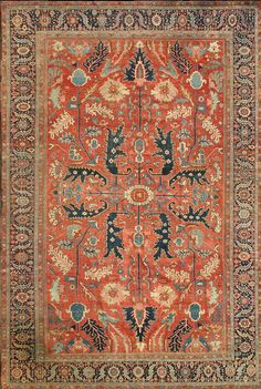 an orange, blue and red rug with floral designs on the bottom half of it