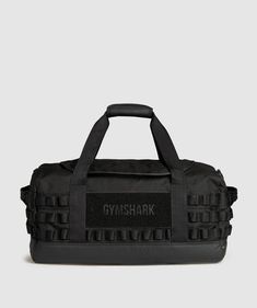 a black duffel bag with the words gymshark on it, in front of a white background